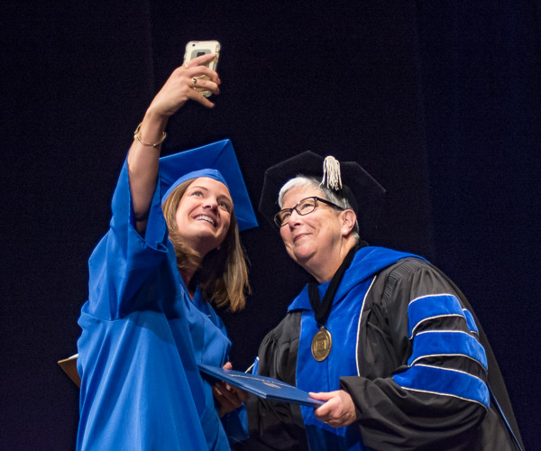 Whether obliging cellphone photographers ... or sharing a laugh, the president makes each graduate's experience individually significant.