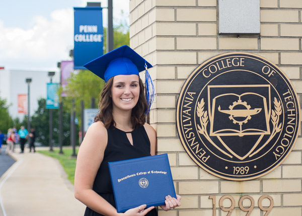 Stopping by the main campus entrance for one last keepsake is radiography graduate Taylor E. Mcniff, of Marietta.
