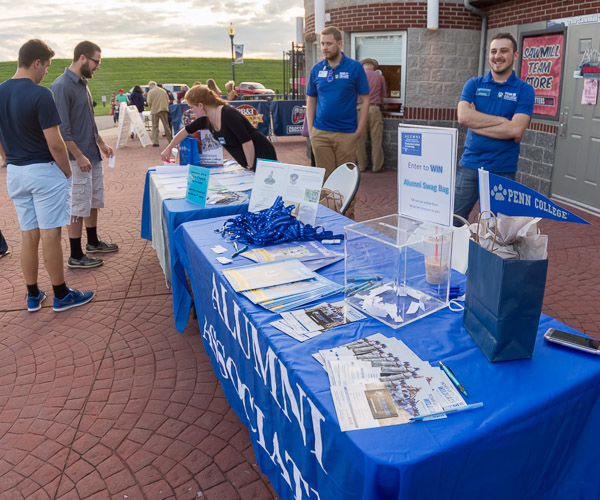 Friendly faces welcome the college community to the ballpark.