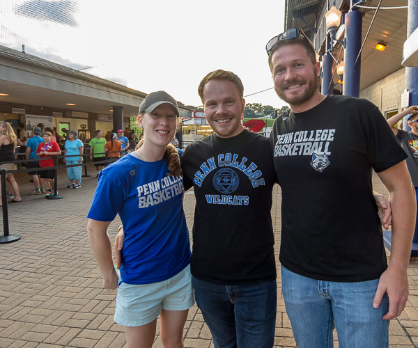 Lauren Healy, women's basketball coach, and admissions counselors Trevor I. Brandt (center) and Sean M. Stout grace the concourse in appropriate evening wear.