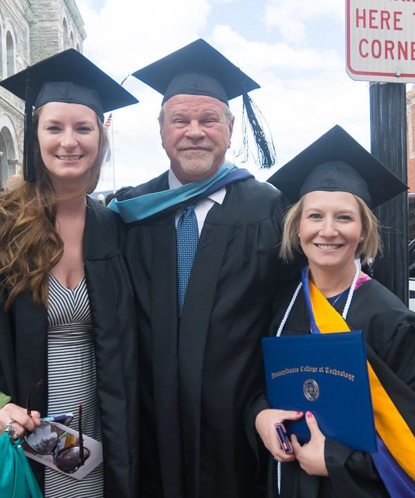 Lauren E. Reed (right), a 2006 radiography alumna, added an applied health studies degree Saturday. Cheering her on outside the theater are Georgia T. Gray, clinical supervisor of radiography, and Cletus G. Waldman Jr., clinical director of radiography.