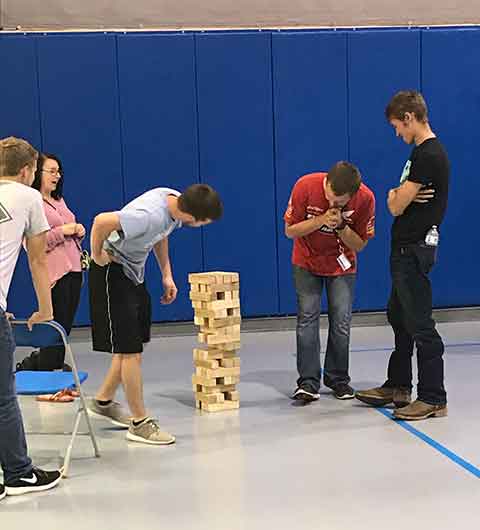 An oversized Jenga game was among the challenges for the 100 students who enjoyed the games (and french-fry bar) during 