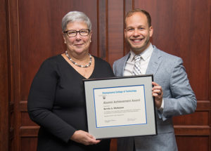Penn College President Davie Jane Gilmour presents the Alumni Achievement Award to Kevin A. Hickman, a 2008 physician assistant graduate.