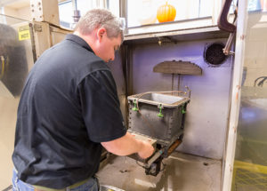 Matthew Jackson, of Tennant Co., Minneapolis, a participant in a recent Rotational Molding Workshop at Penn College, attaches a radio telemetry system to a rotational mold to measure internal air temperature.