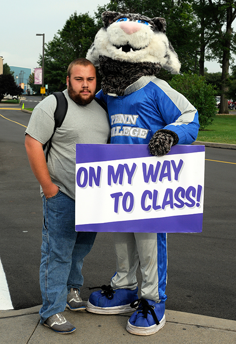 Put your paws together for this winning team: Zachary W. Eckman, of Plum, and the college's awesome mascot.