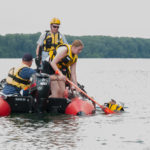 Under watch by Williamsport Bureau of Fire personnel, a student pulls a classmate toward the boat.