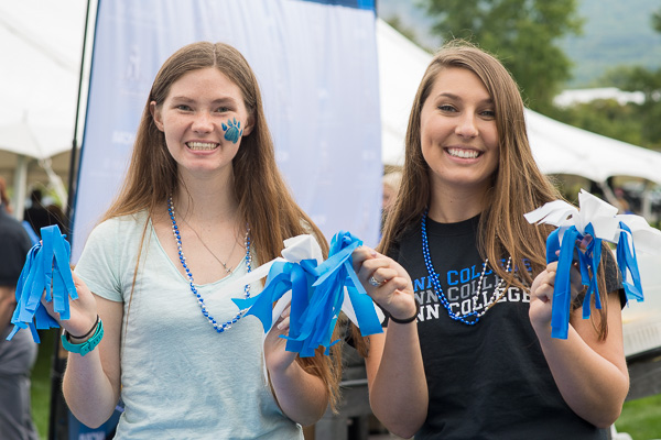 Alyssa E. Sickler (left) and Lindsey A. King show off their handmade pom-poms. Pride tables allowed students to make pennants and headbands and other team-spirit items, as well as face-painting and temporary tattoos.