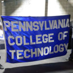 Caleb E. Cartmell (left) and Efrem K. Foster represent Penn College at a Beaver Stadium celebration of university unity. 