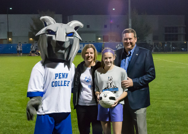 Carolyn R. Strickland, vice president for enrollment management/associate provost; Elliott Strickland, vice president for student affairs; and daughter Emma join the mascot during a halftime of the soccer game. The Stricklands provided the money to purchase two Wildcat outfits based on the new logo design.