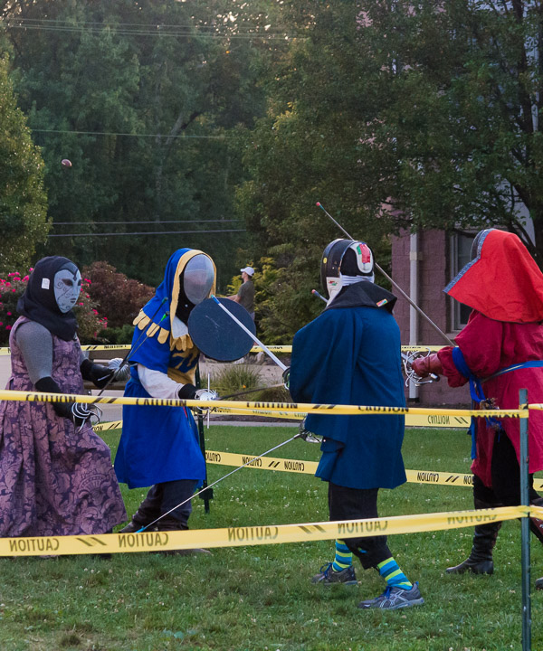En garde! Suitably surrounded by caution tape, fencing enthusiasts cross swords on their cordoned turf.