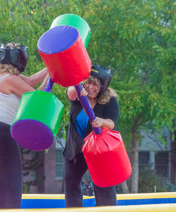 Amicably rival siblings – event organizer Susan M. Phillips, a Dining Services assistant manager, and Sherry A. McKinney, secretary to the director of student activities – battle in the jousting arena.