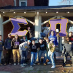 ... and continue the celebration with a larger group (and oversized cutouts of the Greek letters that form their fraternity's name).