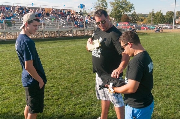 Jeremy R. Bottorf (center), coordinator of intramural sports and campus recreation, distributes some Wildcat mementos during a break in the athletics action.