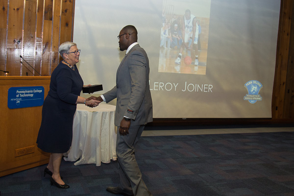 Joiner, who traveled to campus from his home in Colorado, steps up to receive accolades from President Gilmour. 