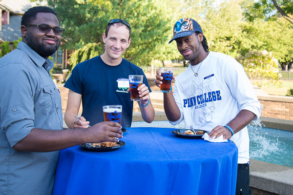 Toasting their reunion at Oktoberfest are (from left) Semeon R. DeBarros, ’17, aviation maintenance technology and applied management; Charles M. Stankye IV, ’16, residential construction technology and management: building construction technology concentration; and  LaQuinn N. Thompson, ’16, applied human services. 