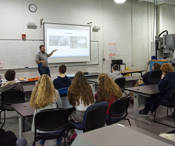 Manufacturing engineering technology student Logan B. Goodhart, of Chambersburg, talks with high school visitors about the process for students to build a successful Baja vehicle in a session titled “Discover Computer Aided Manufacturing.”