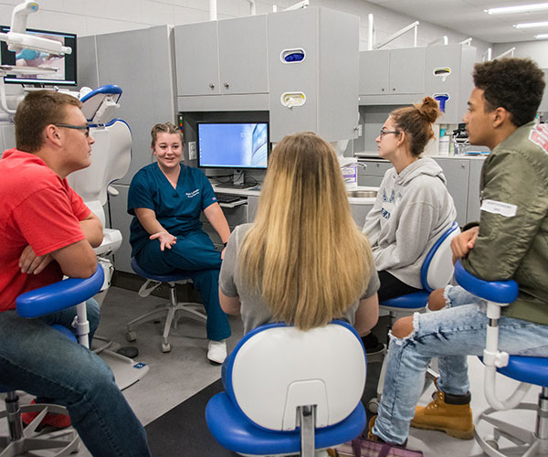 Dental hygiene student Michayla J. Roberts, of Newville, chats with visitors about oral health care – including what amount of toothpaste really is necessary.