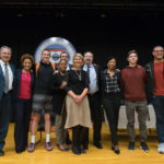 Mackey (center) shares the stage with the evening's cast.
