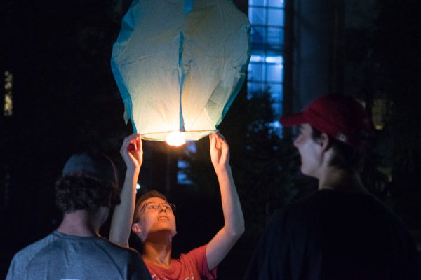 Steadying his lantern for takeoff, a student adds to the collective hope for a cure. 