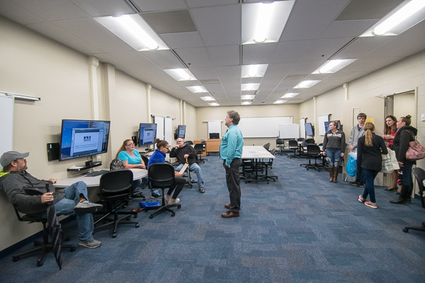 Chip D. Baumgardner (center), associate professor of business administration/management, introduces instructional space dedicated to the college's new innovation majors.