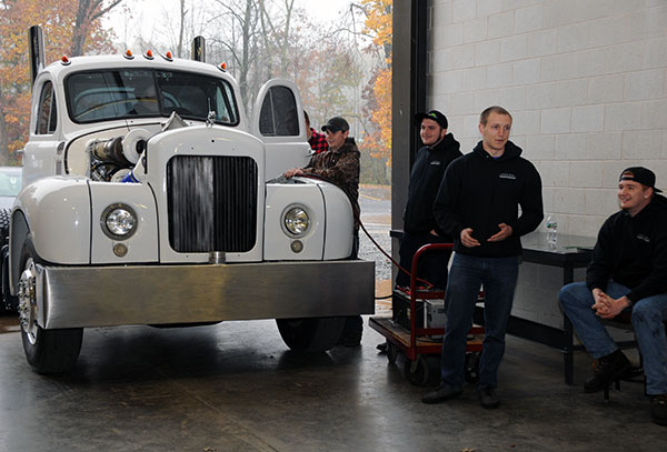 Members of the Diesel Performance Club demonstrate an ongoing student project: a 1959 Mack 