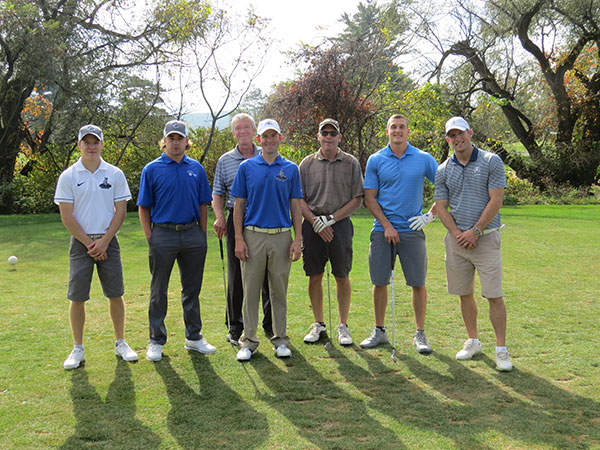 Matt R. Haile (center), an employee, alumnus and Wildcat golf coach, fronts some tee-ready talent.