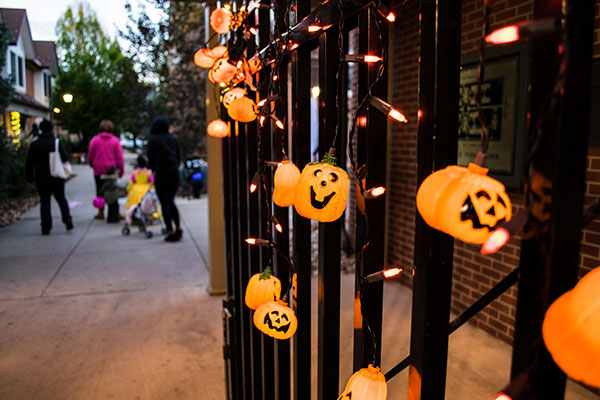Jack-o'-lanterns on The Village gate light the way to Halloween fun.