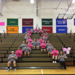 Wildcat women and their Elmira College counterparts form a pink ribbon in the stands Tuesday evening.