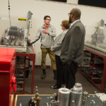 Seth J. Balkey, of State College, a junior in applied technology studies, is among students giving Cipriani and Ramsay a tour of the mechatronics lab. 