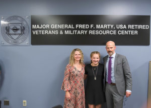 Patrick Marty, vice president for college relations and a former Army field artillery officer, joins wife Trisha and daughter Teagan in dedicating the veterans resource center that bears his father’s name.