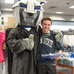 Nicholas Brock Santalucia, a health information management major from Williamsport, picks up his academic regalia – and earns an endorsement from the college mascot.