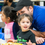 Dining Services' Daniel S. Falzone enjoys the festivities with daughters Julianna and Maria.