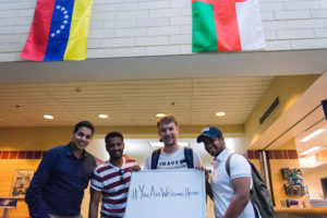 Penn College students Nader M. Alotaibi, of Saudi Arabia; Yousef I. Asiri, of Saudi Arabia; Laurent P. Maehr, of Austria; and Majid A. Alamri, of Oman, gather in front of flags that are part of a permanent display in the college’s Bush Campus Center. The flag display, the makeup of which will change to reflect the student population, is designed to recognize the international students among the college’s scholars.
