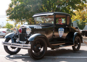 Officer Charles E. O'Brien Jr. sits in his restored 1929 Ford Model A coupe outside Penn College Police headquarters.