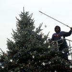 With Old Glory providing an apt backdrop for his ascent to the treetop, Haefner adeptly places the final strand of stars.