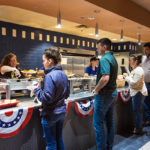 Patriotic bunting adorns the serving line.
