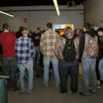 Circling the makeshift arena, welding students gather for the competition and cheer on their classmates.