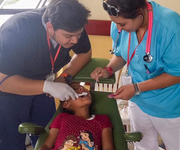 Ramirez and Lugo-Schlegel apply fluoride varnish in the dental area of the clinic.