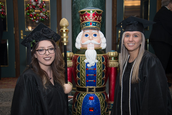 Casey L. Smith (left) and Elizabeth J. Rabuck, earning their degrees in business administration: management concentration, in the CAC lobby