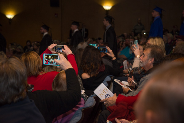 Cellphones galore capture the procession of grads.