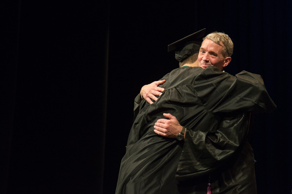 John M. Good III, automation and computer integrated manufacturing instructor, receives a hug from his son, John M. IV, an engineering design technology graduate. 