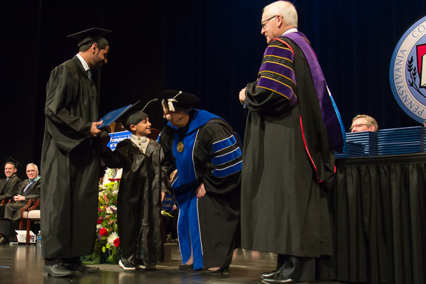 In a sweet moment not lost on the vocally delighted audience, the college president interacts with the son of plastics grad Bader A. Alamri – clad in matching cap and gown ...