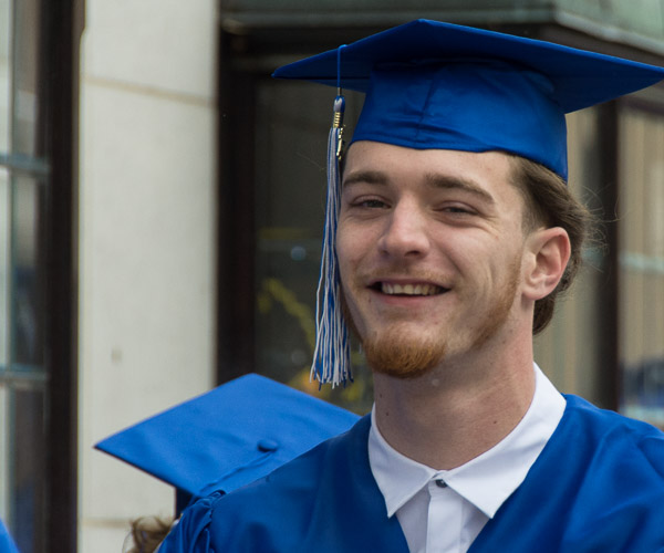 The procession up Fourth Street brings out grins.