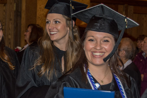 New nursing graduates Nicole Marie Mestach (background) and Francesca B. Monse beam as they exit the Arts Center.