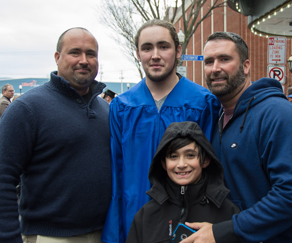 Brody C. Bushnell takes an after-ceremony photo with his family, including a young cousin.