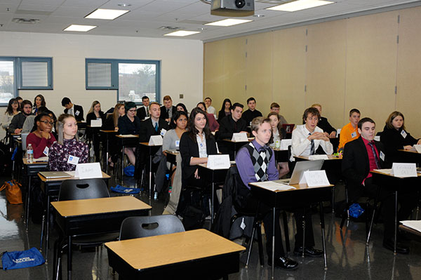 Fronted by table tents identifying their adopted states of origin, delegates prepare to tackle a packet of resolutions.