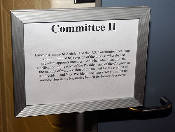 A sign outside a classroom outlines the serious committee work being done within.