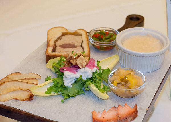 Their spread includes a curly endive salad, haymarket pate en croute with spicy chili relish, cured and smoked salmon with a spicy mango chutney, and fondue served with roasted pear slices.