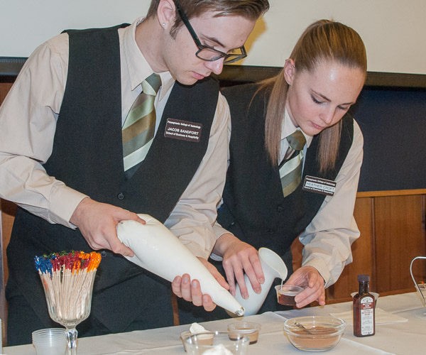 Hospitality management students Jacob D. Sandfort, of Wyalusing, and Heather L. Croft, of Sayre, mix a coffee-based “mocktail” for guests. They are in the Hospitality Beverage Management Service and Controls course.