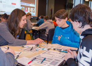 Alicia McNett, instructor of computer information technology at Penn College, guides a high school student in programming an Ozobot. The workshop was part of an “Hour of Code” event hosted by Penn College and attended by several high schools. It is part of an international initiative to encourage interest and confidence in the skills needed to join the computer science workforce.